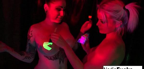  Black-light babes Nadia White and Ophelia suck off a colorful cock